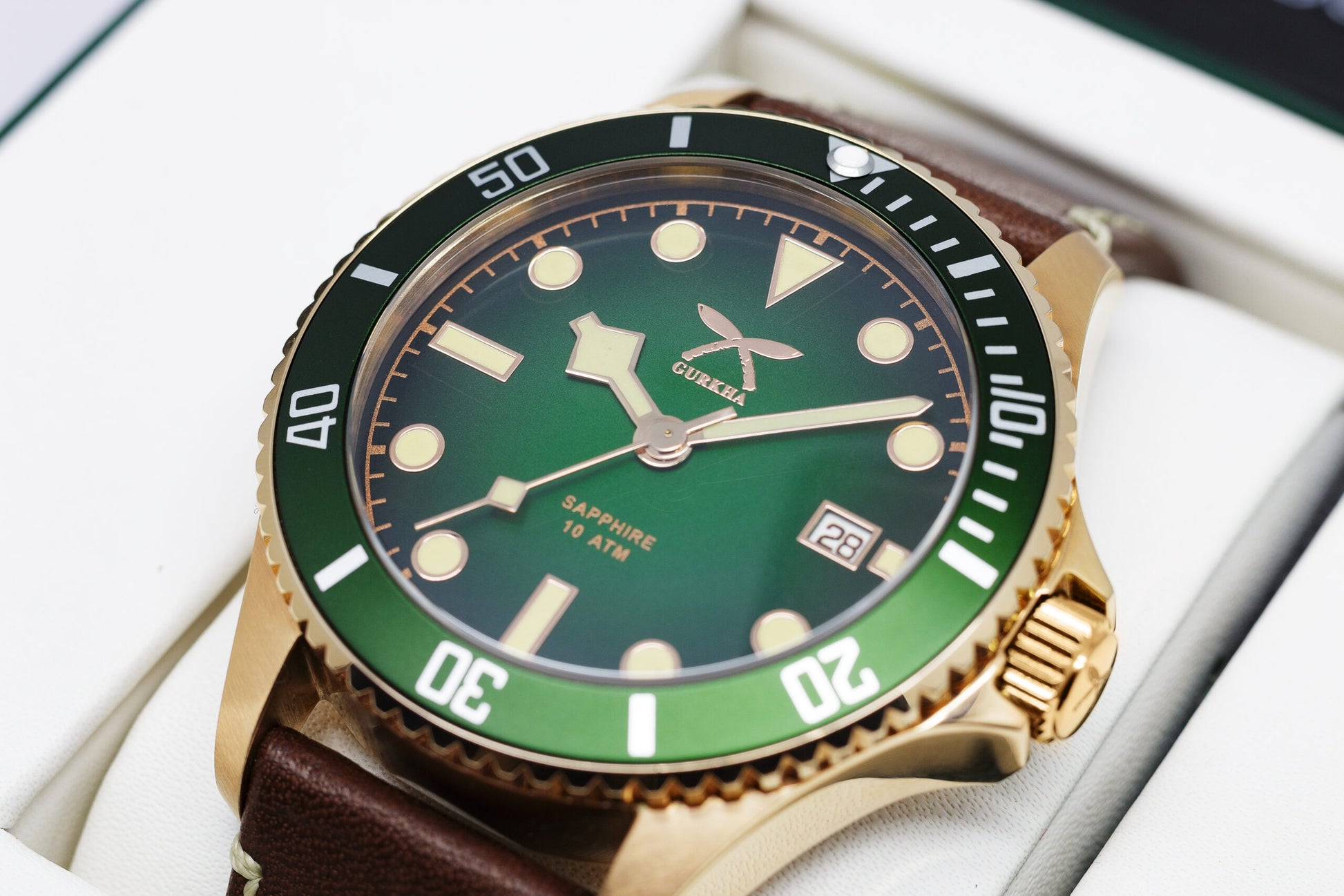 Green dial watch with rotating bezel and leather strap
