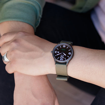 Combat green watch with nylon strap on wrist